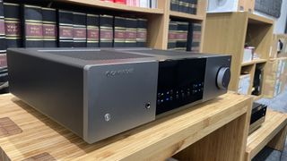 Cambridge Audio EXA100 integrated amplifier on hi-fi rack in front of bookcase