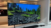 The LG B4 OLED TV photographed on a white shelf with rocky scenery on the screen